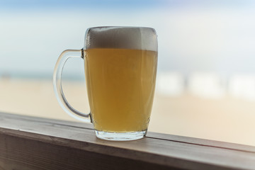 A glass of cold beer on the terrace of the summer restaurant.