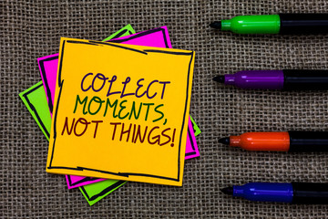 Text sign showing Collect Moments, Not Things. Conceptual photo Happiness philosophy enjoy simple life facts Written on some colorful sticky note 4 pens laid in rank on jute base