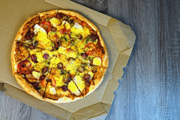  Pizza with cheese and sausages and mushrooms on the table 