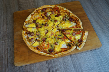  Pizza with cheese and sausages and mushrooms on the table 