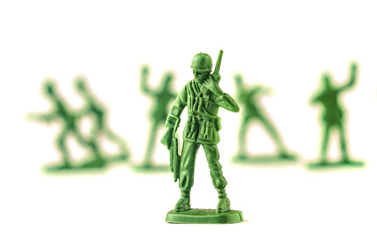 lot of plastic toy soldiers on white background.
