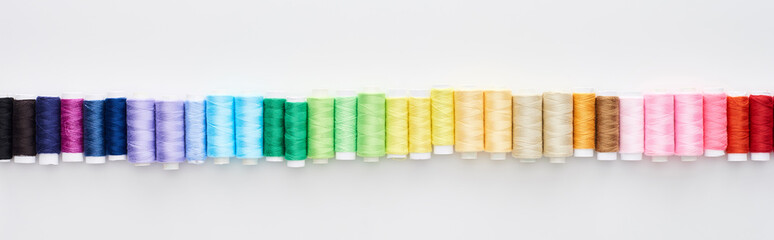 panoramic shot of bright and colorful threads on white background