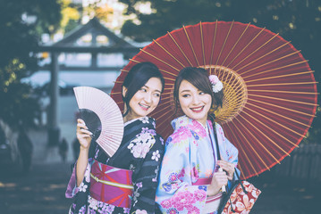 Two japanese girls wearing kimonos traditional clothes, lifestyle moments