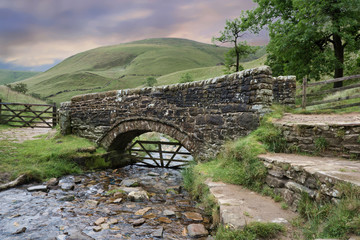 Fototapeta na wymiar Footbridge at the foot of Jacob's Ladder on the Pennine Way: a brisk walk from Edale this section is a popular walk for day walkers due to good transport and rail links.