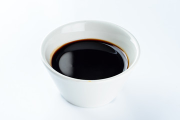 Thick dark soy sauce on a light background