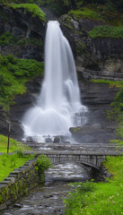Obraz premium Popular waterfalls in Norway. The Steinsdalsfossen has a fall of 50 m and is special because you can walk safe and dry behind it.