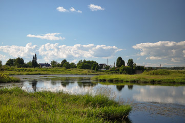 A rural landscape in the European part of Russia on a sunny day with a river