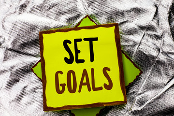 Text sign showing Set Goals. Conceptual photo Target Planning Vision Dreams Goal Idea Aim Target Motivation written Stacked Sticky Note Paper the Silver textured background.