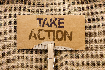 Writing note showing Take Action. Business photo showcasing Strategy Future Actions Procedure Activity Goal Objective written Cardboard Piece Holding By Clip the jute background.