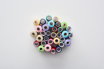 top view of bright and colorful threads on white background