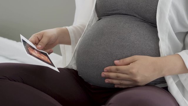 Pregnant women are viewing pictures of babies from ultrasound.