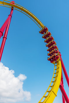 Roller coaster ride under blue sky in theme park