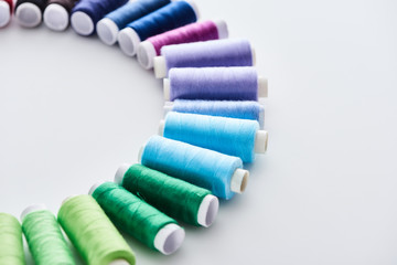 flat lay with bright and colorful threads on white background