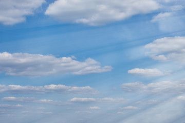 Background in the form of a cloudy sky. Clouds against a clear autumn sky. Sunny day with floating white cloud.