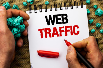 Conceptual hand writing showing Web Traffic. Business photo text Internet Boost Visitors Audience Visits Customers Viewers written by Man Holding Marker Notebook Book jute background