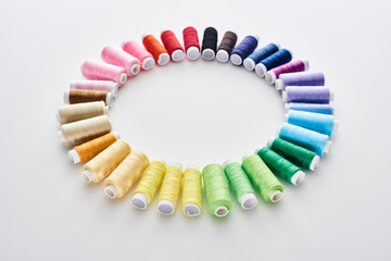 flat lay with bright and colorful threads on white background