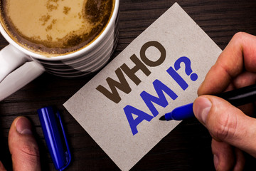 Conceptual hand writing showing Who Am I Question. Business photo text Question Asked Identity Thinking Doubt Psycology Mystery written Man Holding Marker Note Paper Wooden background Coffee.