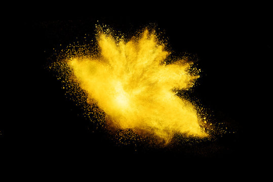 Yellow Powder Explosion On Black Background.