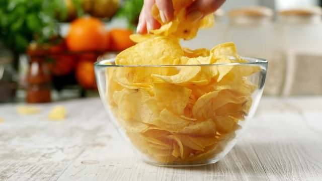 Eating chips from a bowl. Collecting large amounts at once.