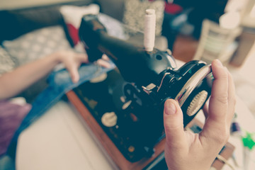 woman tailor using retro sewing machine