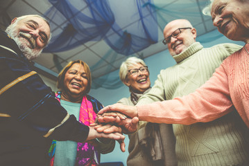 Group of seniors making activities inside the hospice.