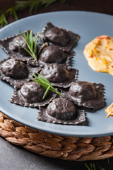 Ravioli with stuffing and gravy. Italian food