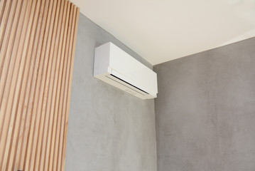  Wooden wall with air conditioner in the flat corner, interior room design.