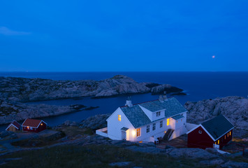 Houses at dusk next to the lighthouse of Lindesnes at dusk, Norway