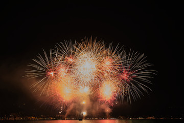 Firework show on Lake Garda, celebration (Sant Ercolano). In the city of Toscolano Maderno Italy. Aerial view.