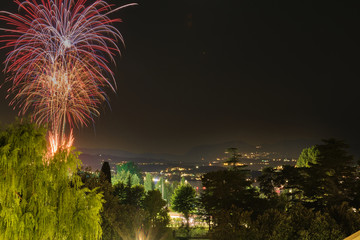 Firework show on Lake Garda, celebration (Sant Ercolano). In the city of Toscolano Maderno Italy. Aerial view.