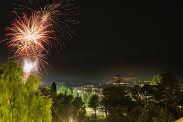 Firework show on Lake Garda, celebration (Sant Ercolano). In the city of Toscolano Maderno Italy. Aerial view.