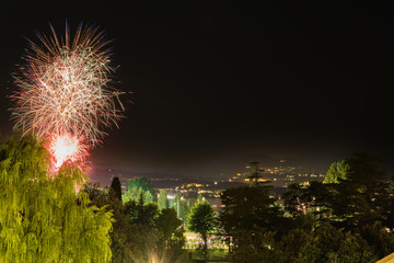 Firework show on Lake Garda, celebration (Sant Ercolano). In the city of Toscolano Maderno Italy. Aerial view.