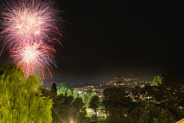 Firework show on Lake Garda, celebration (Sant Ercolano). In the city of Toscolano Maderno Italy. Aerial view.