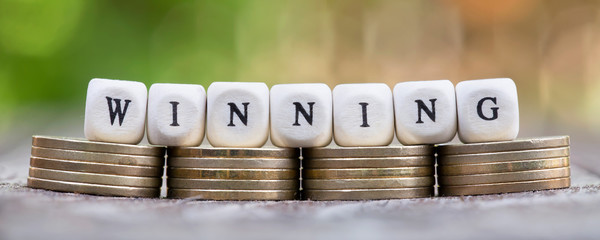 Winning, business success concept, web banner with letter cubes and money coins