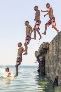 Man jumping from pier