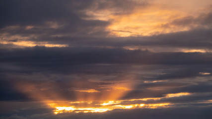 rain clouds and sunbeams at sunset.