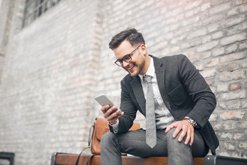 Businessman checking phone on pause