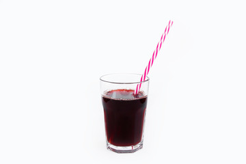 glass cup with red fruit cherry juice and a drinking can