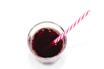 glass cup with red fruit cherry juice and a drinking can