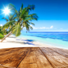 Table background and palm tree with the ocean view.