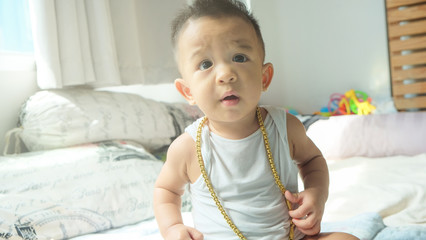 Rich infant baby boy with gold necklace ornament decoration