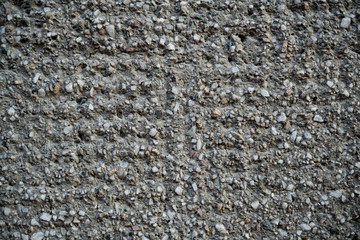 Texture of an old cracked concrete wall. Background image of a worn gray concrete surface