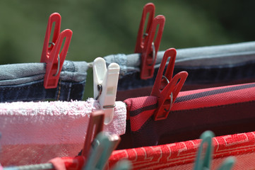 Clothes are dried attached with clothespins to the ropes