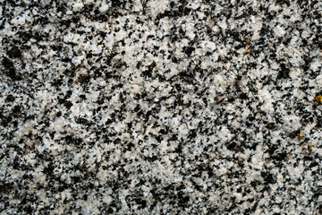 The texture of the stone overgrown with moss. Background image of a boulder