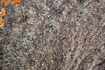 The texture of the stone overgrown with moss. Background image of a boulder