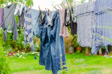 Clothes drying on a washing line in a residential garden.