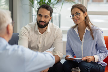Cute longhaired female person sitting opposite her director