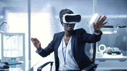 Young Black Female Virtual Reality Engineer/ Developer  Wearing VR Headset Creates Content. She's...