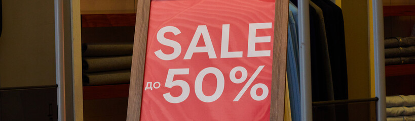 50 discount on advertising layout above the clothing line in a shopping department store for shops, business fashion and advertising concepts