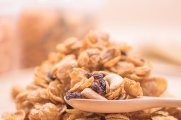 Delicious cereal caramel cornflakes warm tone background. A Breakfast cereal made by flakes of corn.